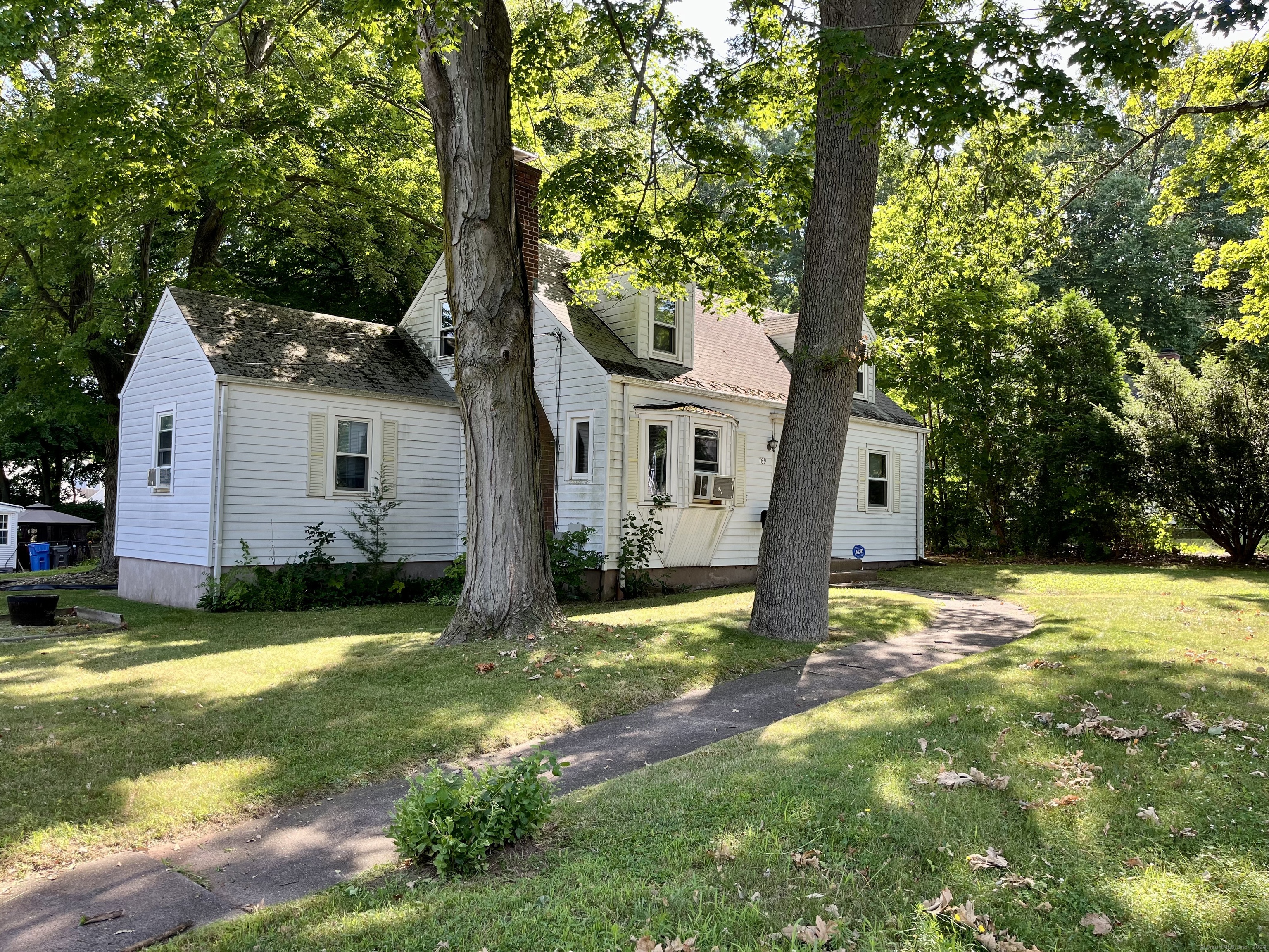 a front view of house with yard and green space