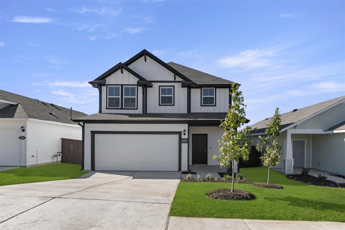 a front view of a house with a yard and garage