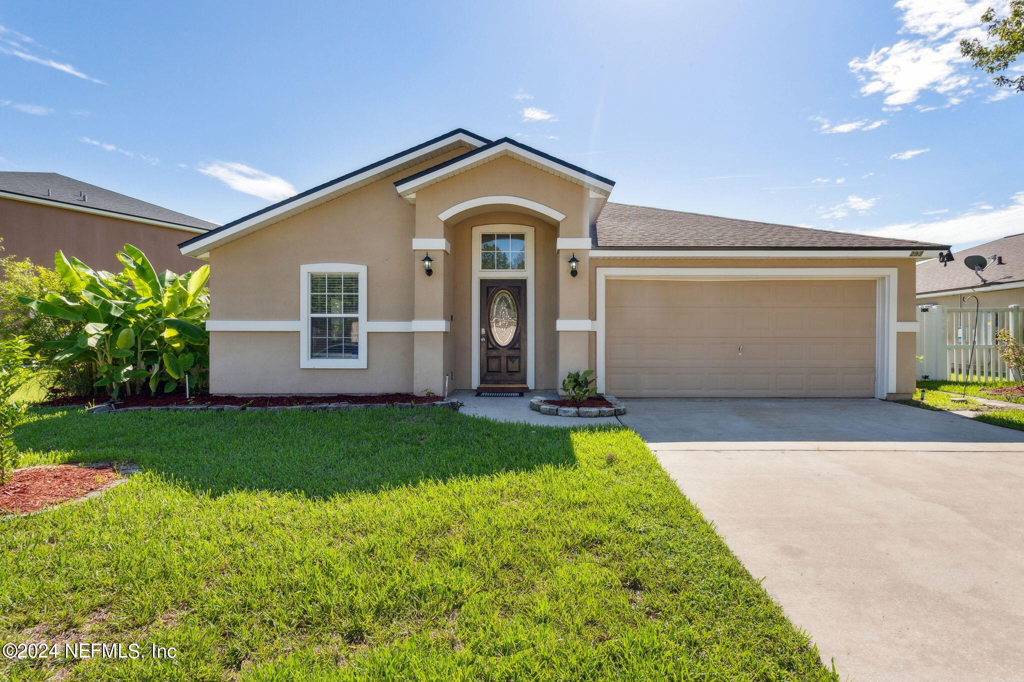 a front view of a house with garden