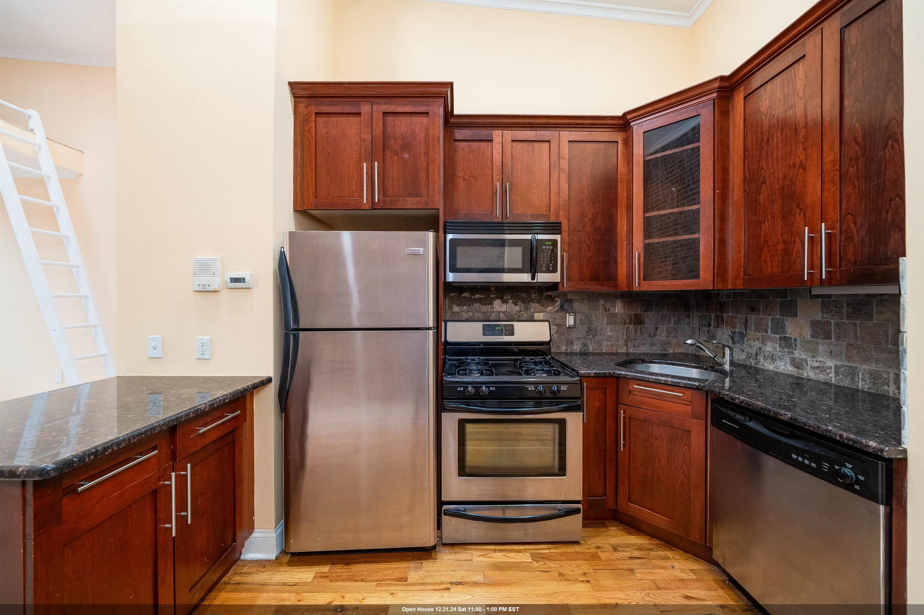 a kitchen with stainless steel appliances granite countertop a refrigerator stove and sink