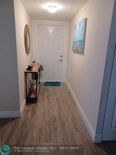 a view of room with furniture and wooden floor