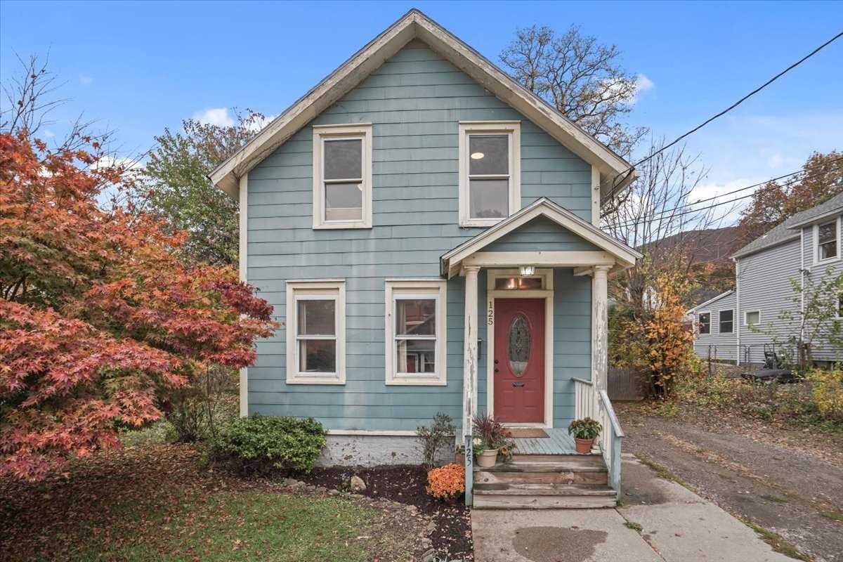 a front view of a house with garden