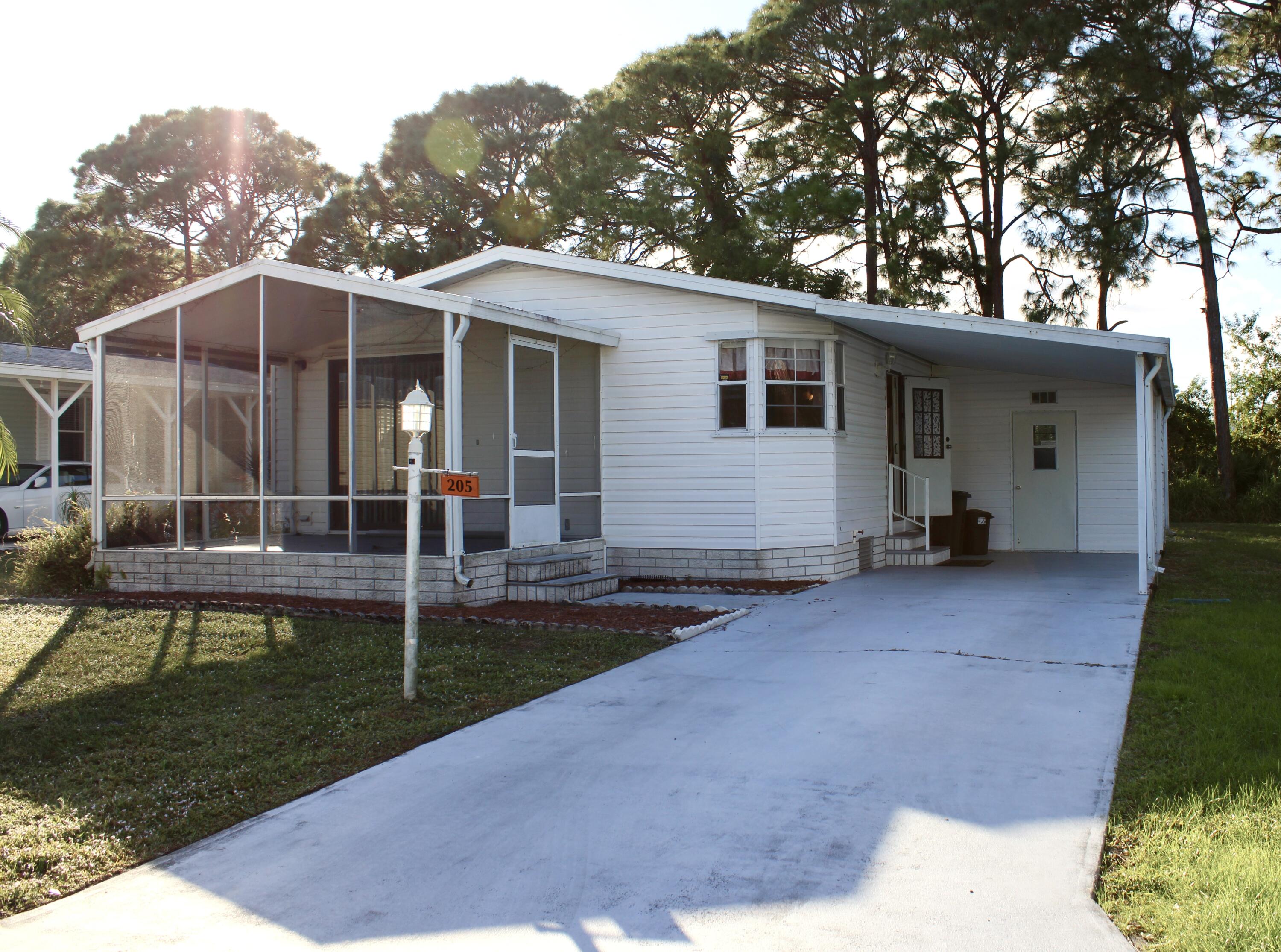 a view of a house with backyard and trees