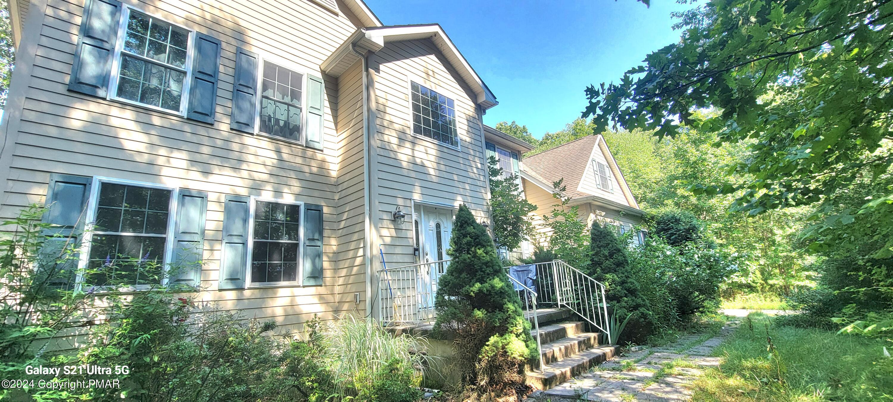 a view of a house with a yard and sitting space