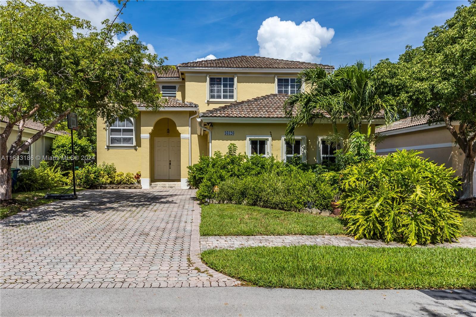 a front view of a house with a yard