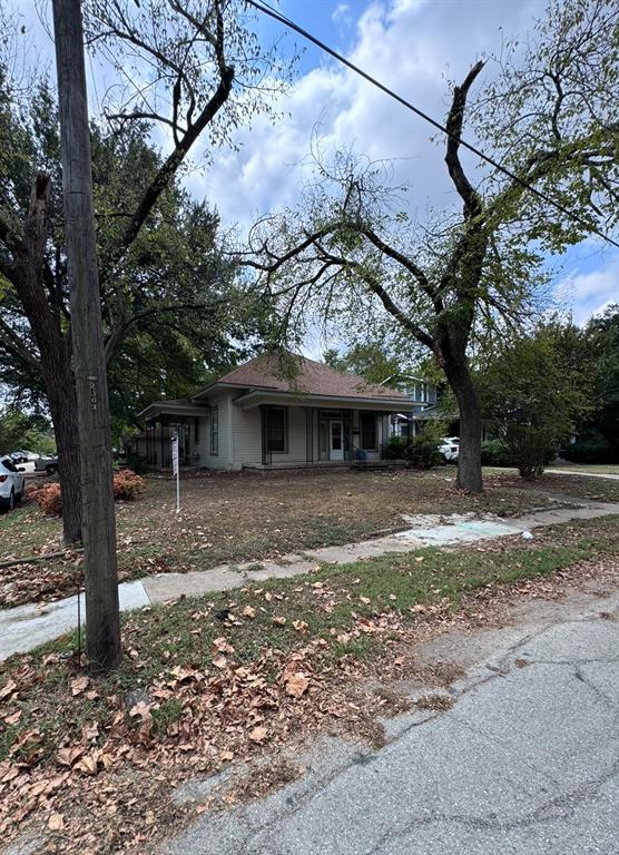 a view of a house with a tree in the yard