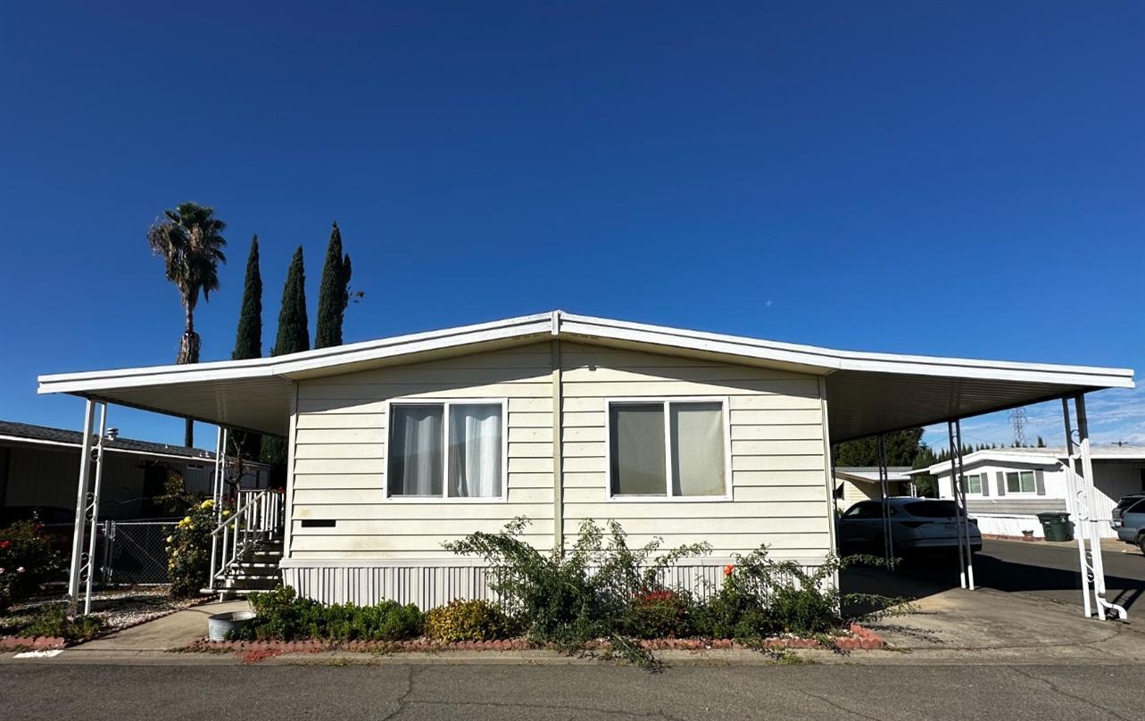 a front view of a house with a garden