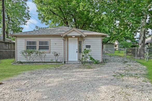 a house that has a tree in front of a house