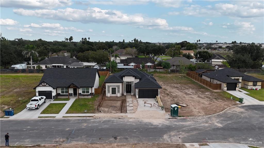 an aerial view of a house with swimming pool and mountains