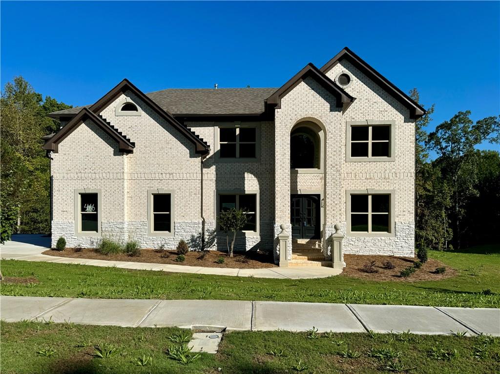 a front view of a house with a yard