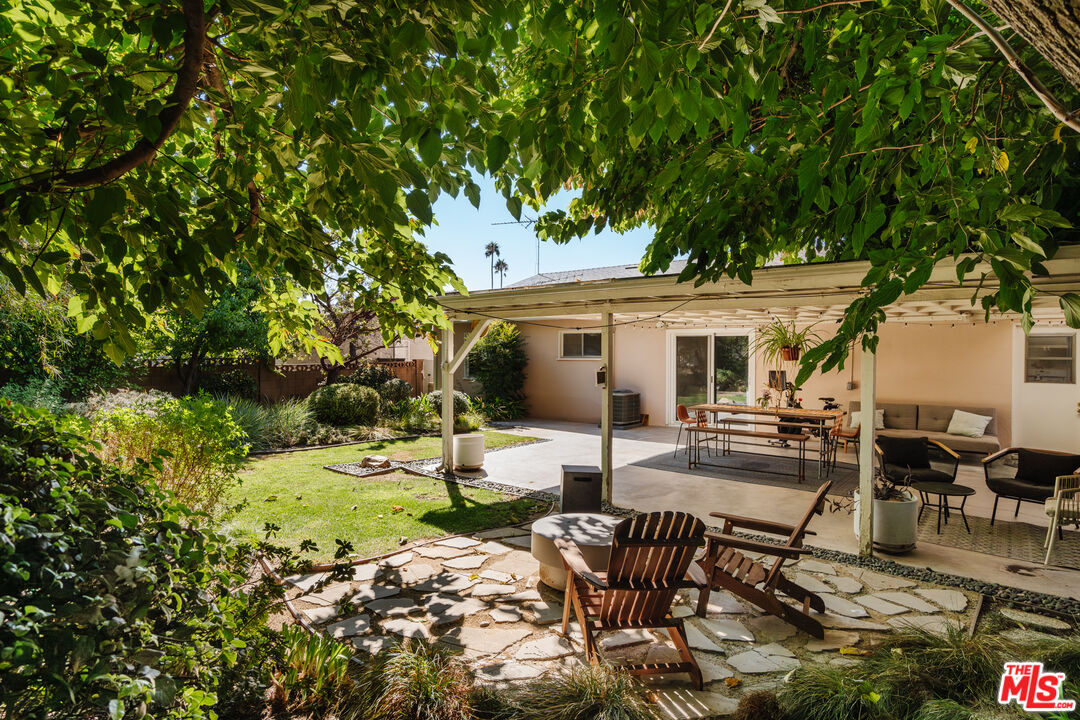 a view of a house with backyard sitting area and garden