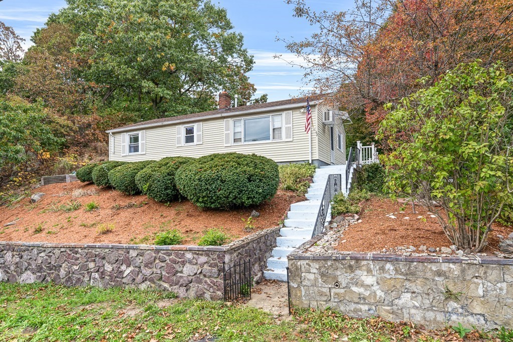 a front view of a house with garden