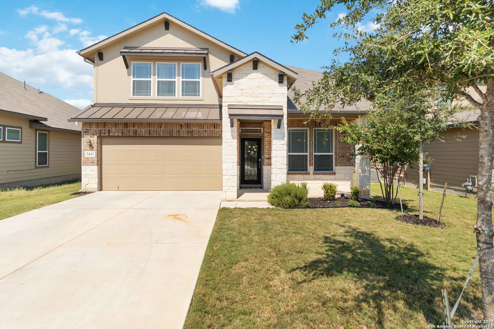 a front view of a house with a yard and garage