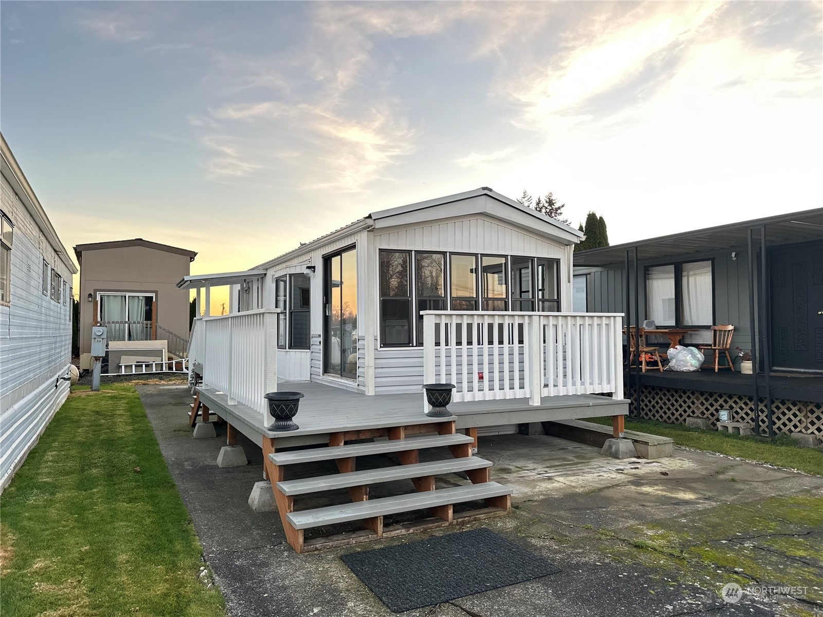 a view of a house with a yard and deck