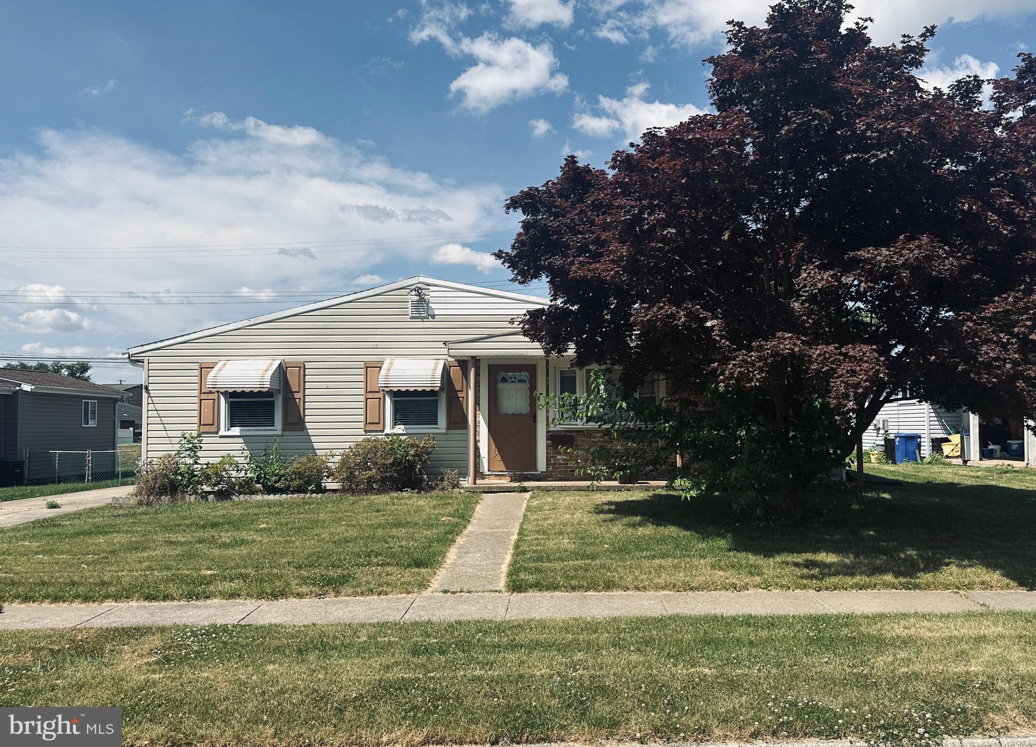 a view of house with yard and green space