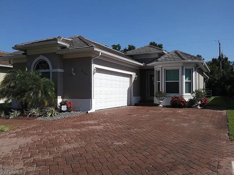 a front view of a house with a yard and garage