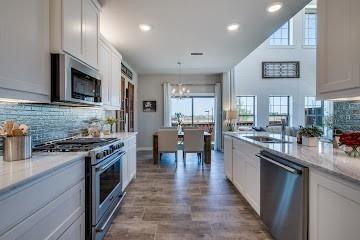 a kitchen with lots of counter top space and stainless steel appliances