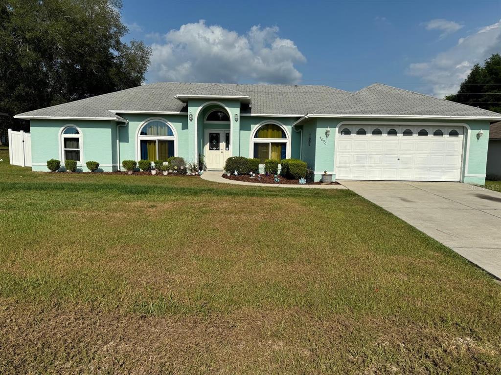 a front view of a house with a garden and porch