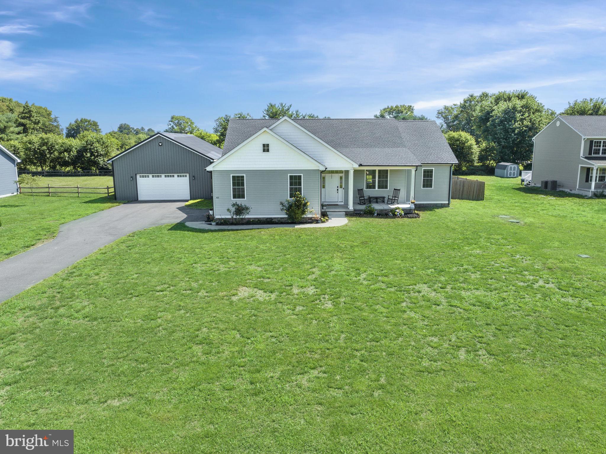 a front view of a house with yard porch and green space