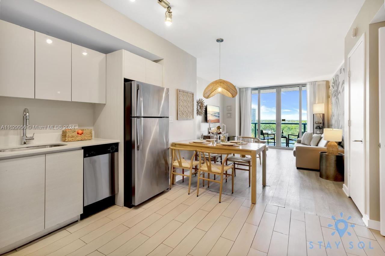 a kitchen with a sink appliances and cabinets