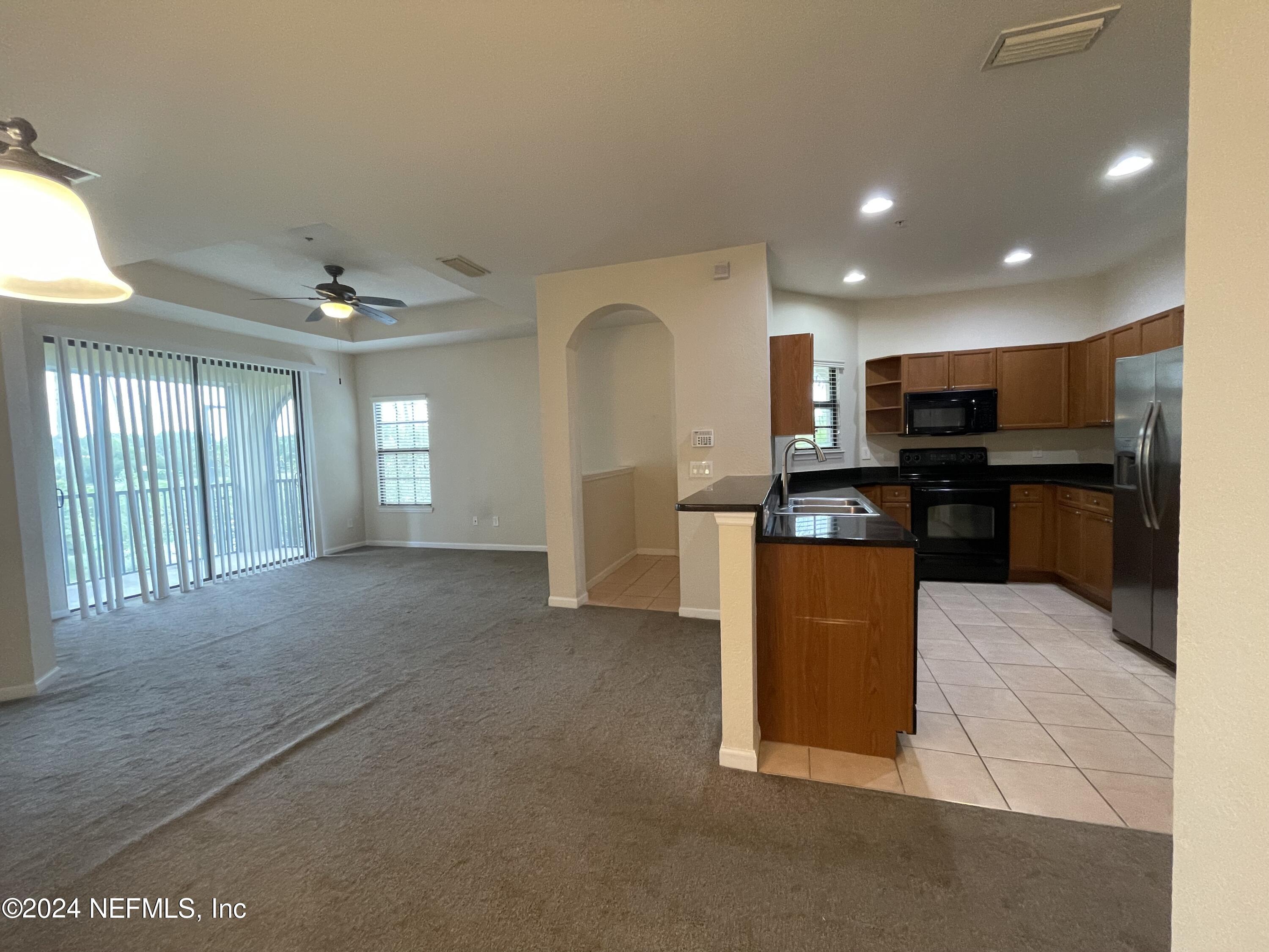 a view of kitchen with furniture and stainless steel appliances