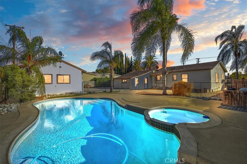 a view of a house with swimming pool and a yard