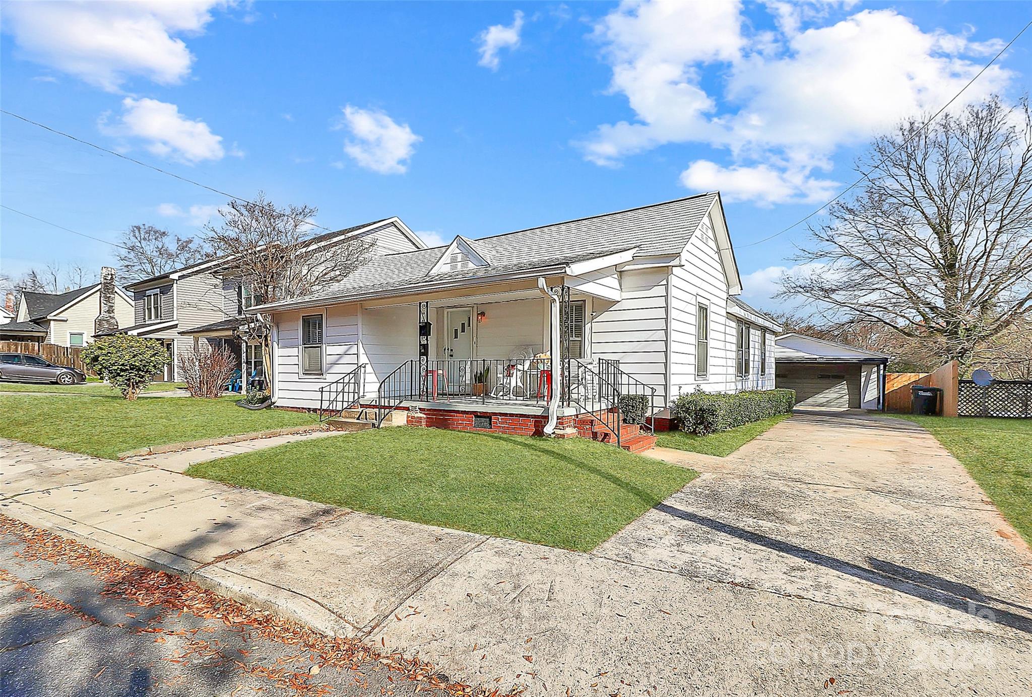 a front view of a house with a yard and porch