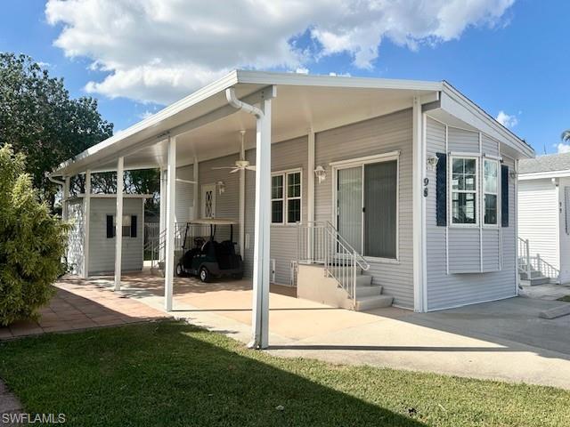 a view of a house with backyard and porch