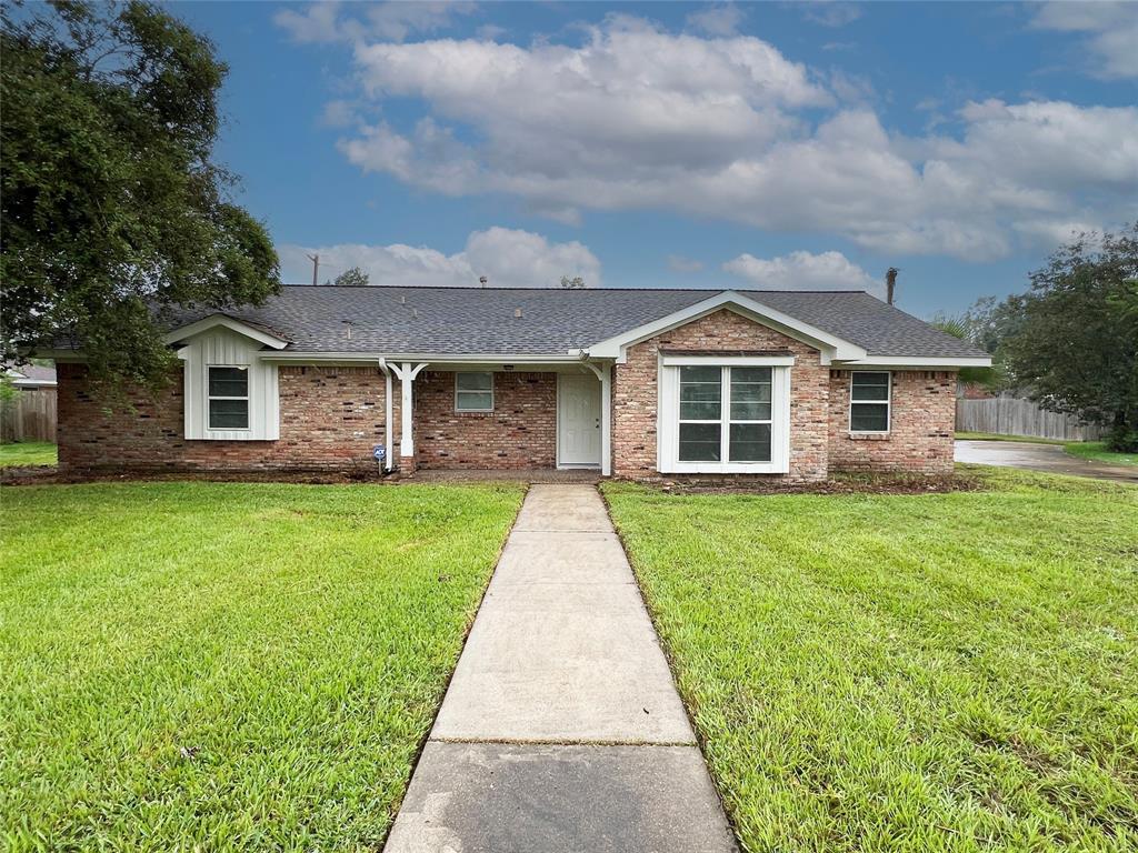 a front view of a house with a garden and yard