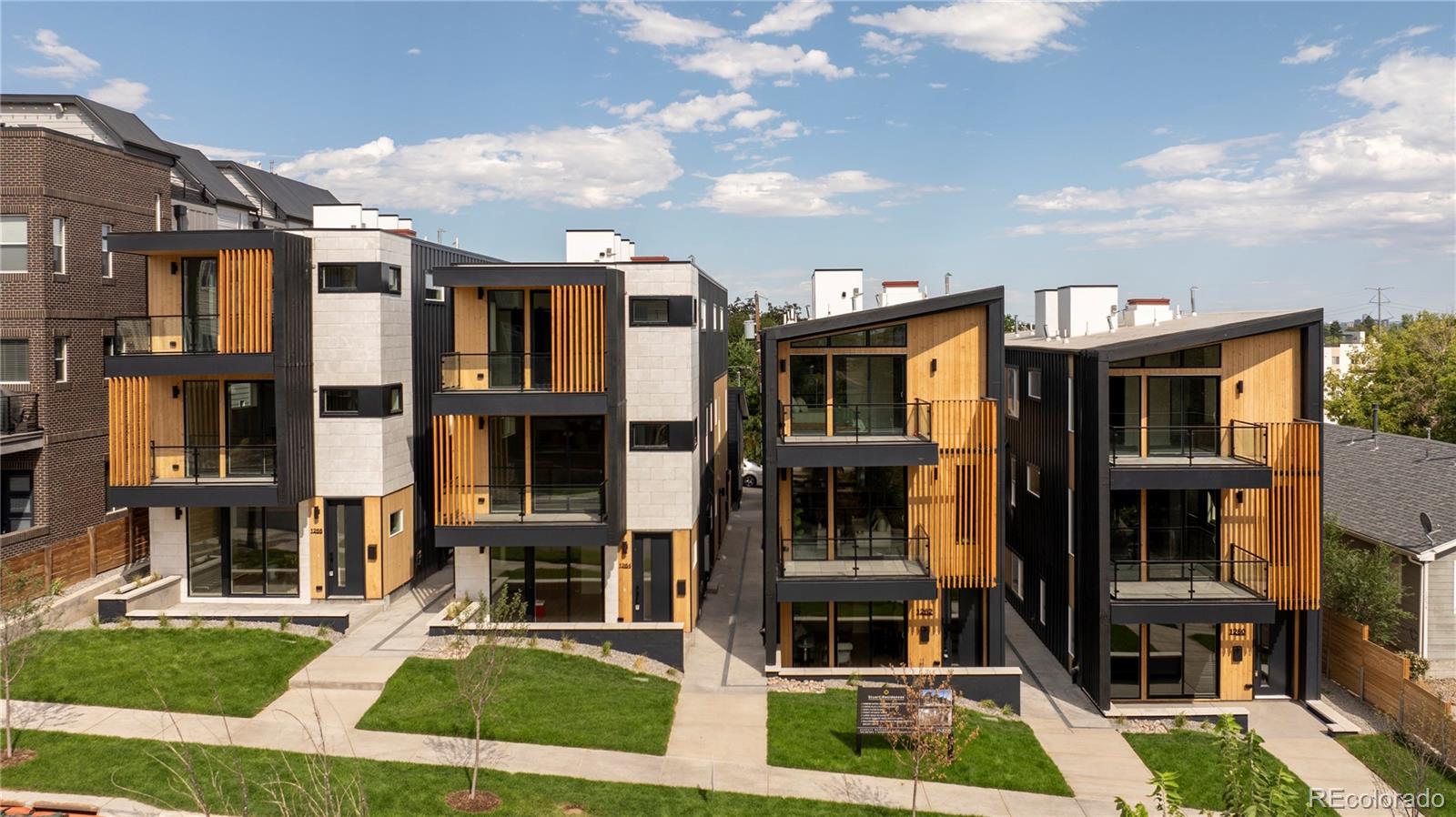 a front view of a residential apartment building with a yard