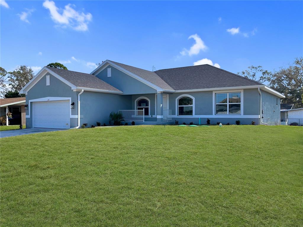 a front view of house with a garden