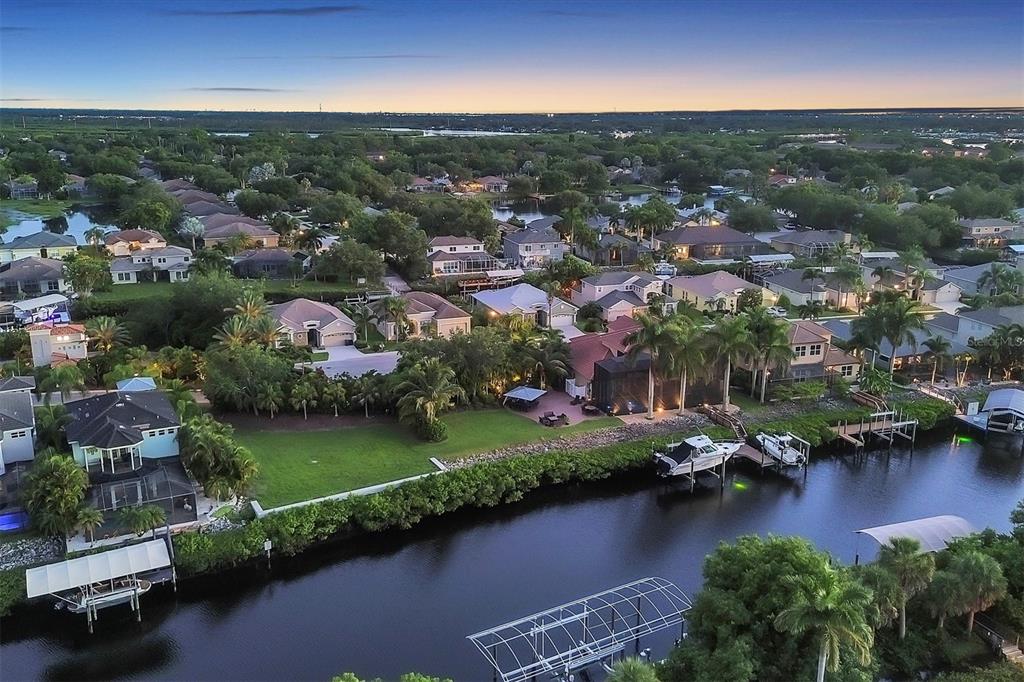 an aerial view of residential houses with outdoor space and lake view