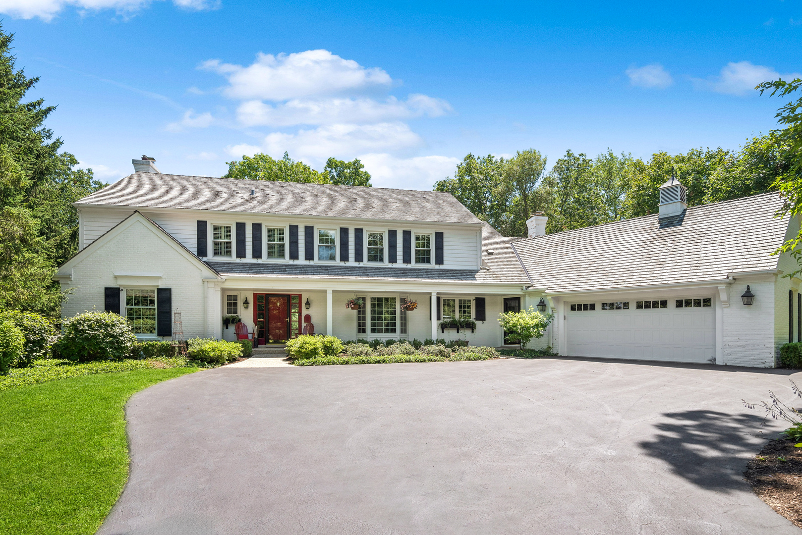 a front view of a house with a garden