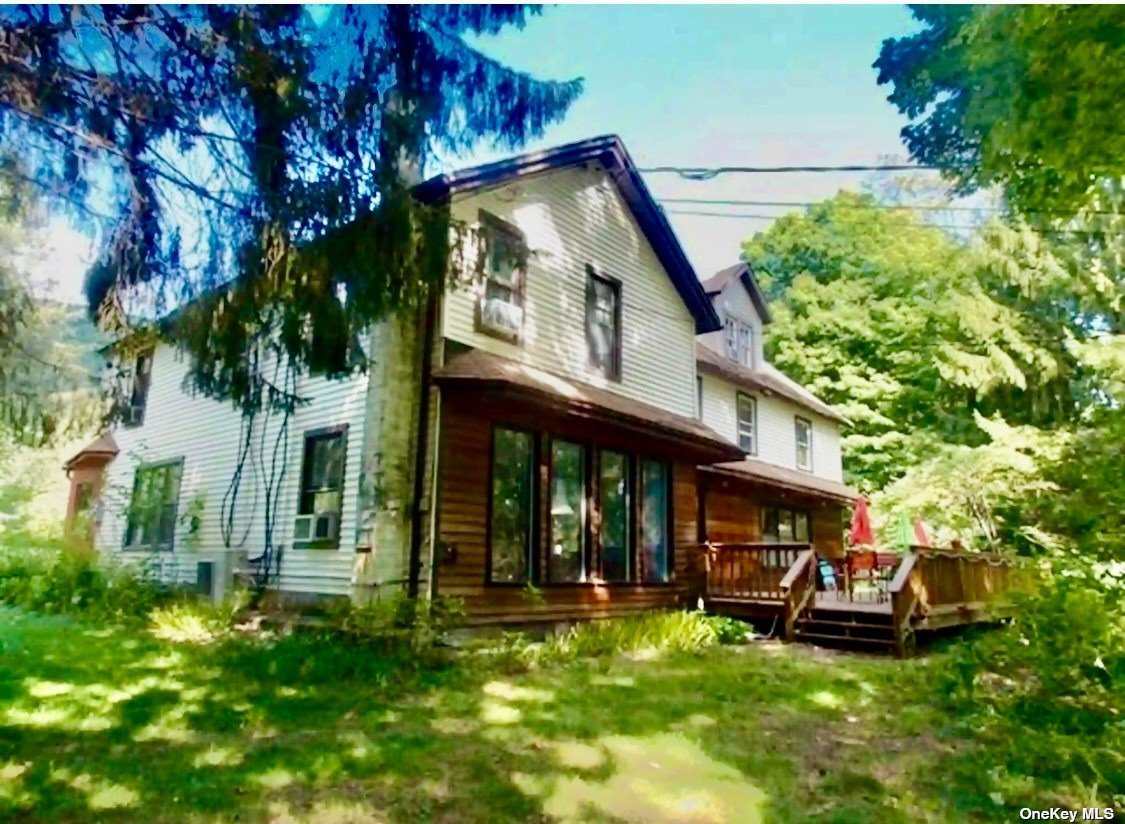 a view of a house with backyard sitting area and garden