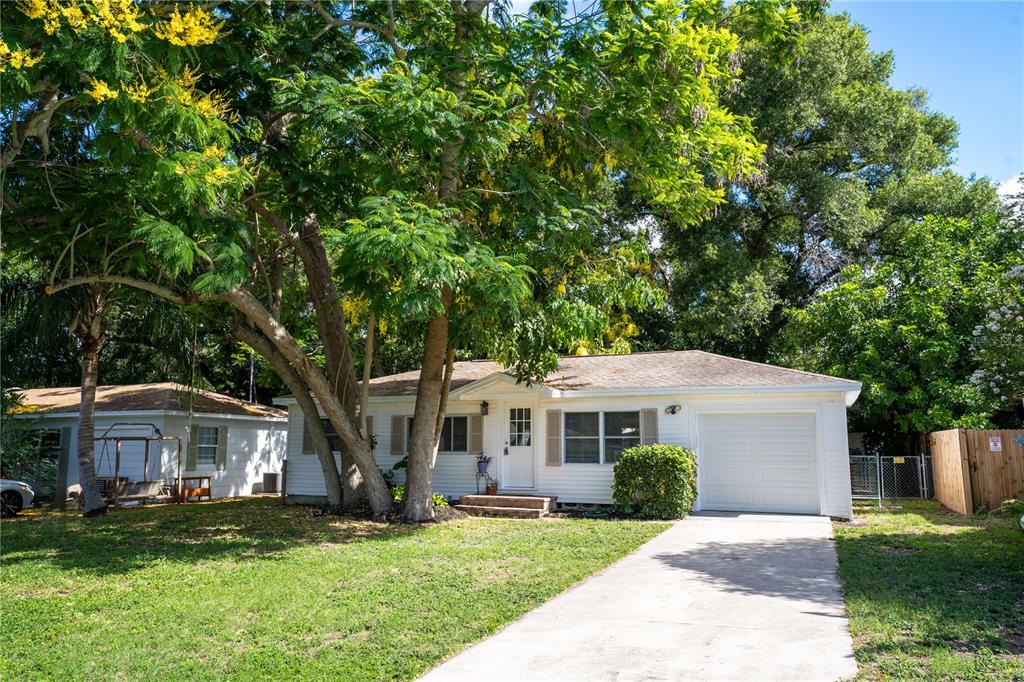 a front view of a house with a garden