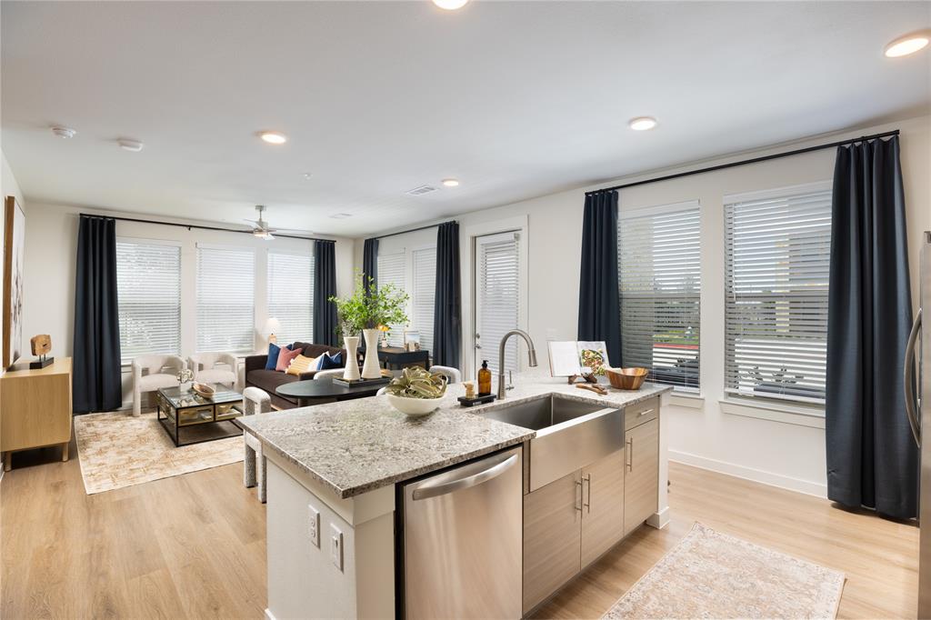 a kitchen with sink attached with living room