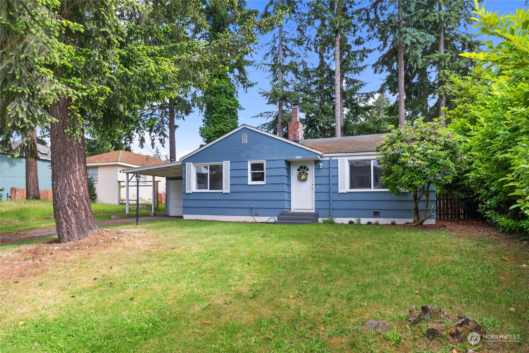 a house that has a tree in front of the house