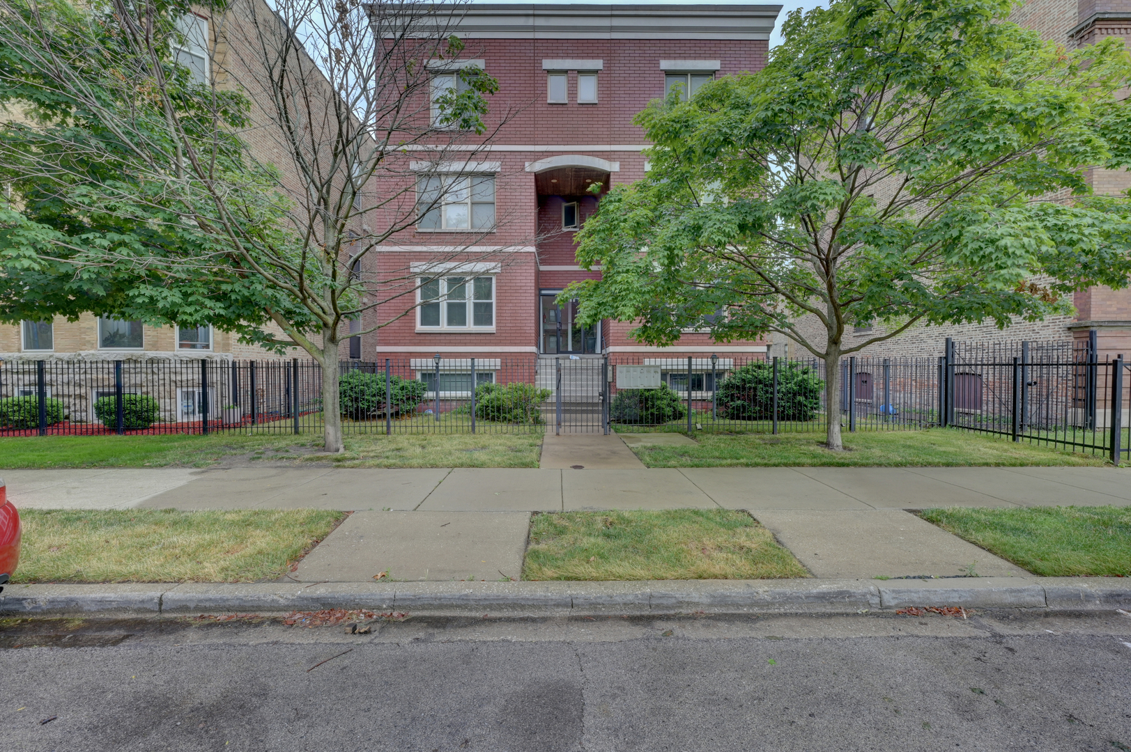 a view of a brick building next to a yard