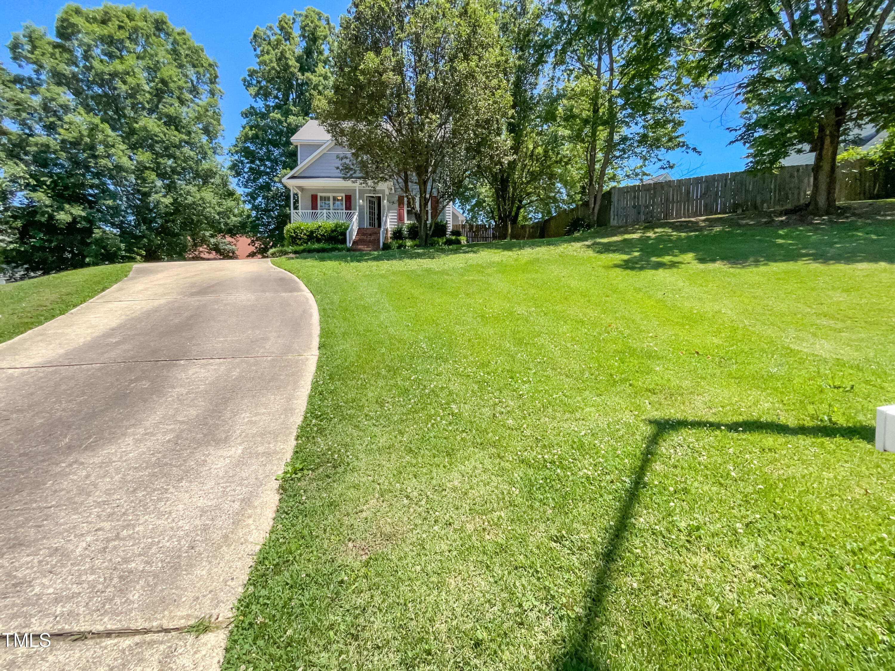 a front view of a house with yard and green space