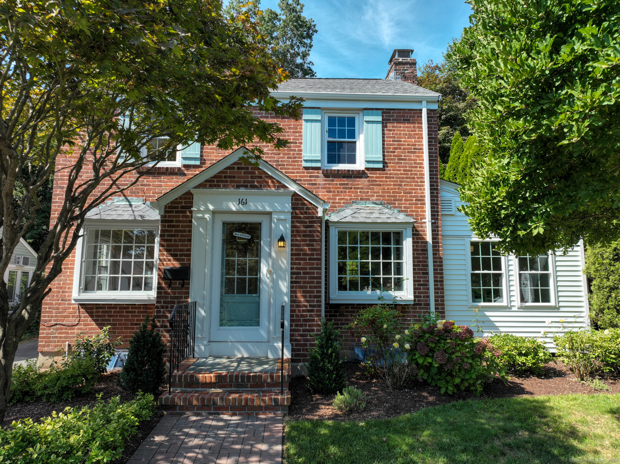 a front view of a house with garden