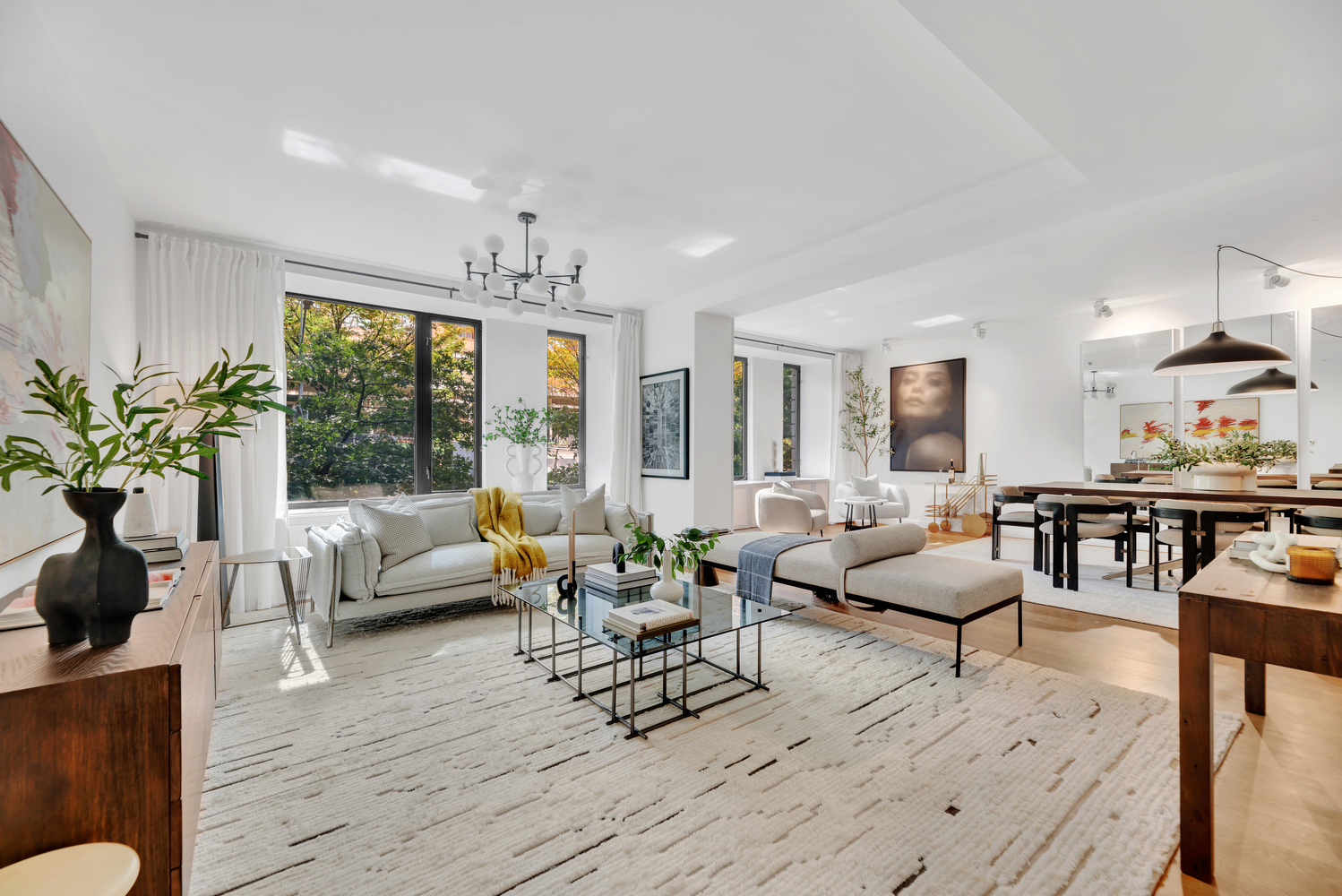 a living room with furniture and large windows