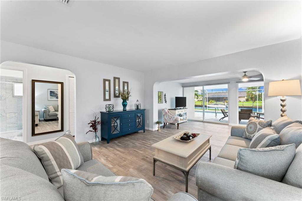 Living room featuring ceiling fan and light hardwood / wood-style floors