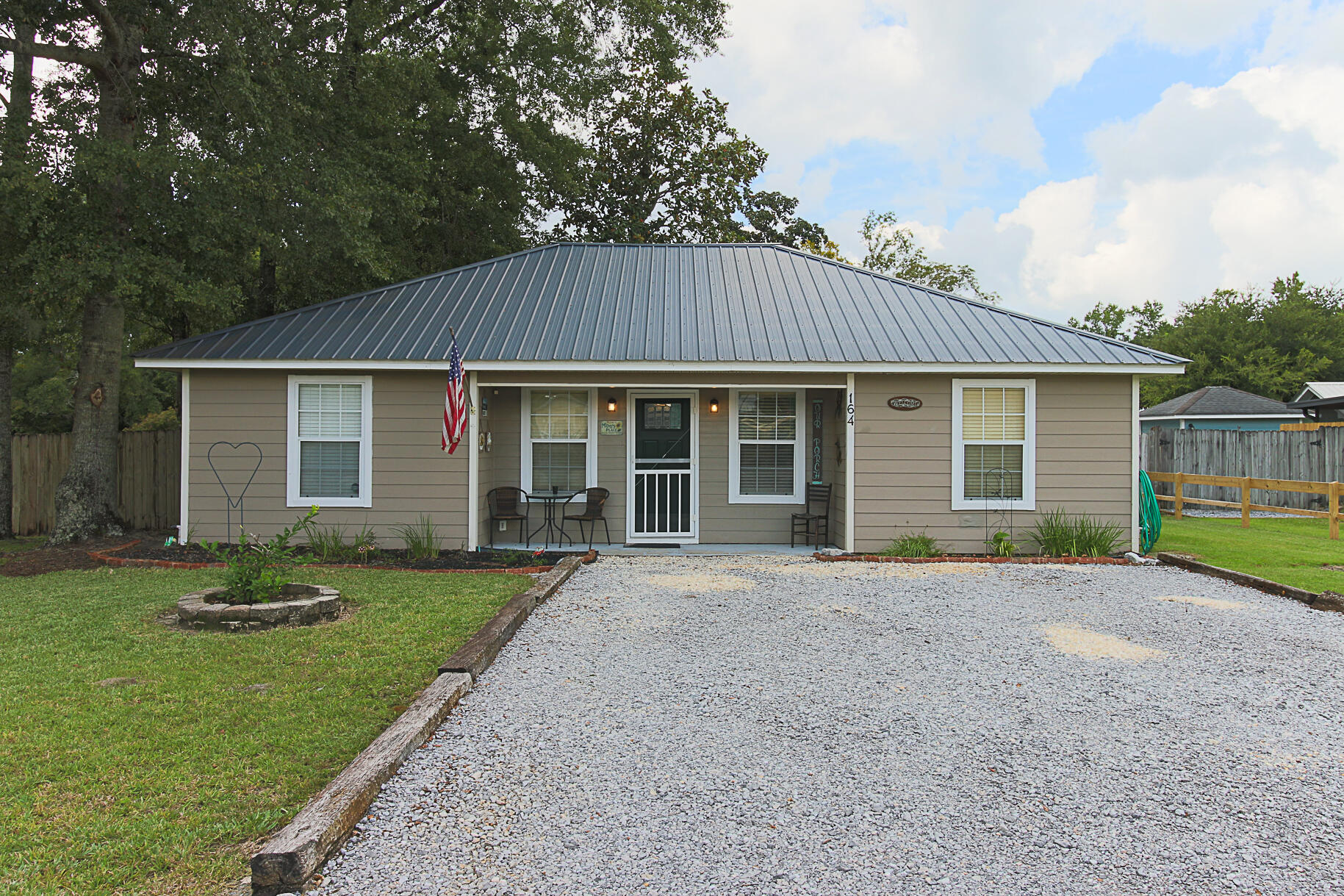 a front view of a house with a garden and patio