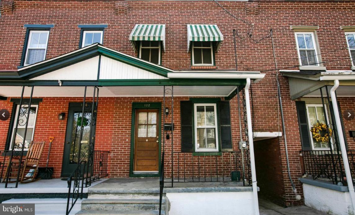 a view of a brick house with large windows