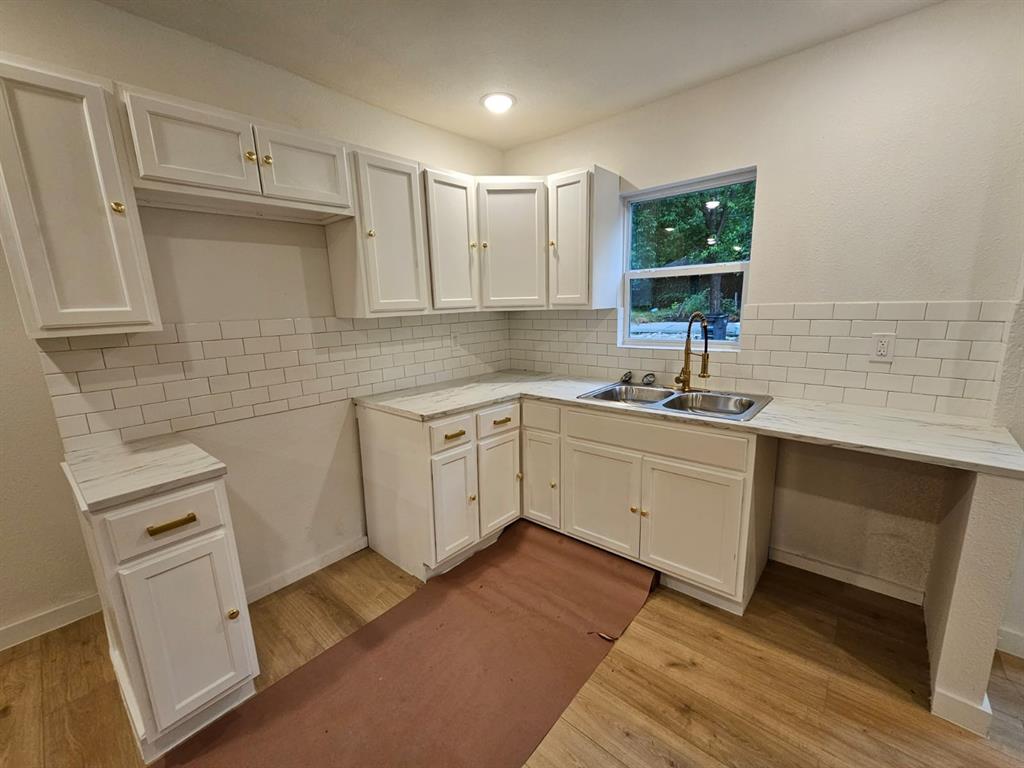 a kitchen with a sink cabinets and window