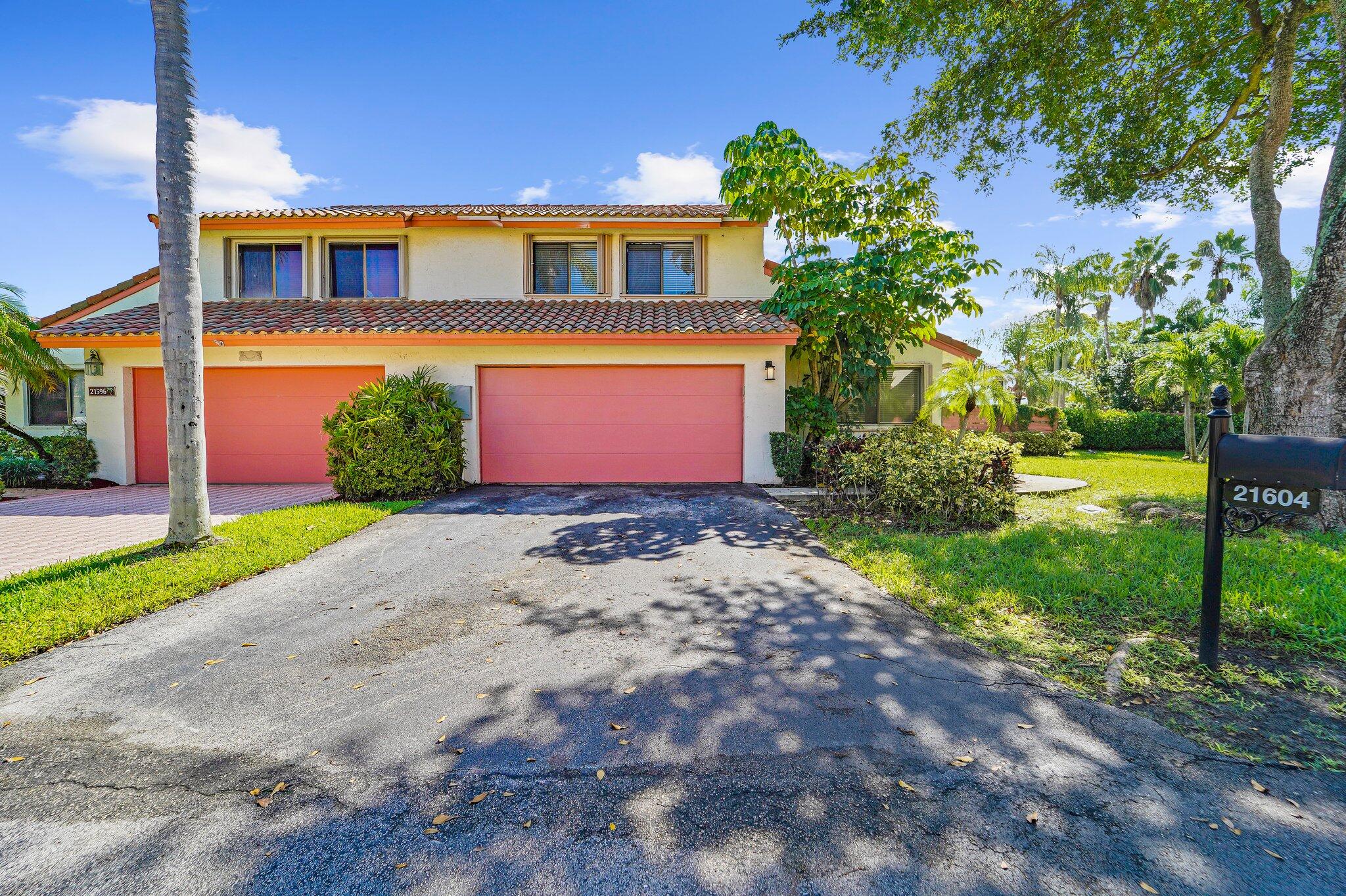 a front view of a house with a yard and a garage