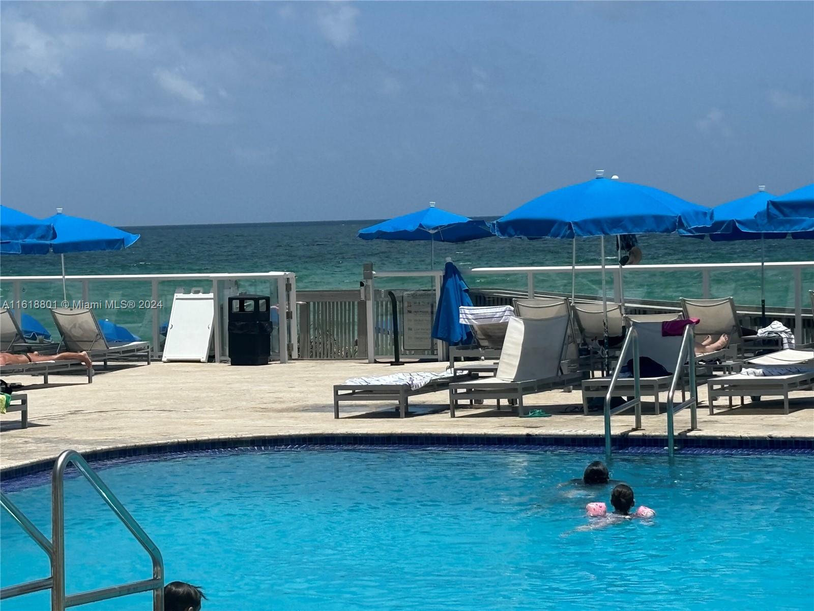 a view of a swimming pool and lounge chairs