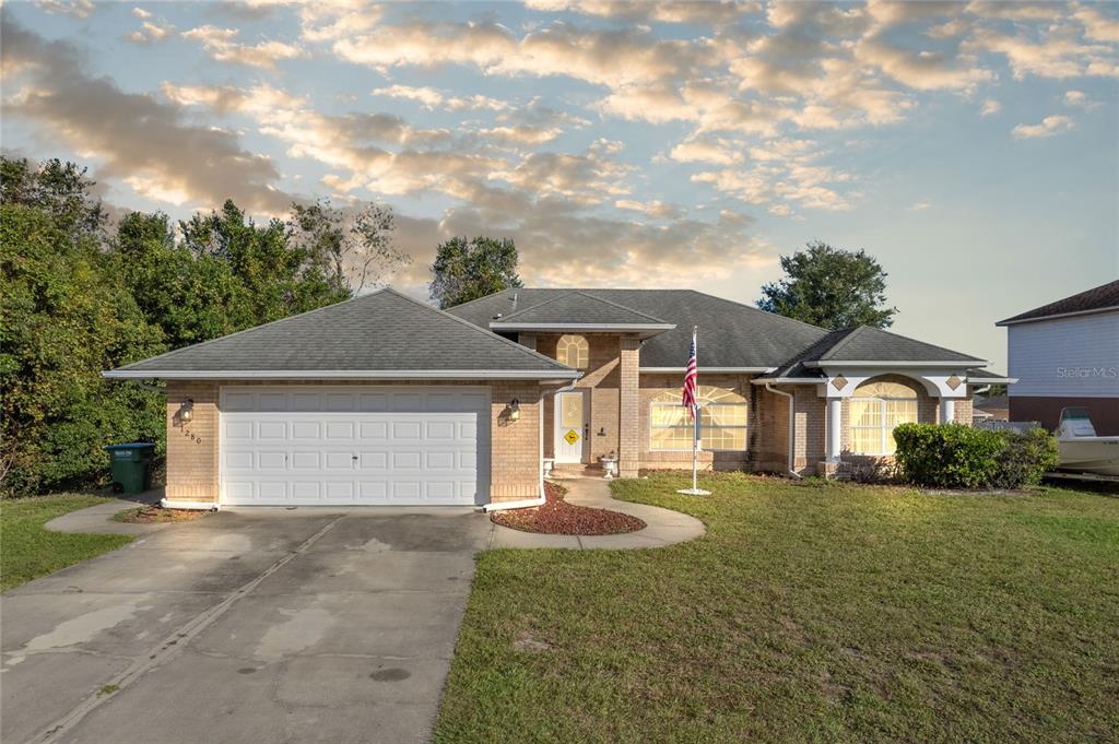 a front view of a house with a yard and garage