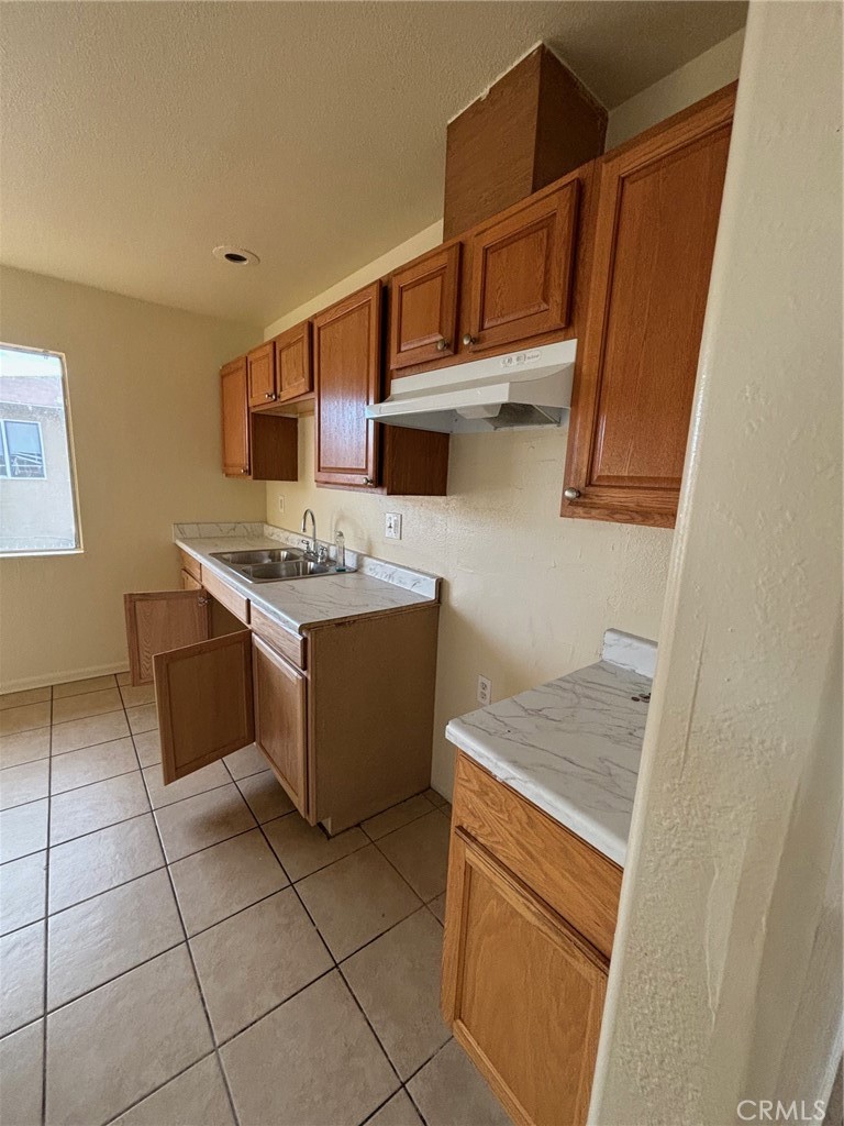 a kitchen with a stove top oven and cabinets