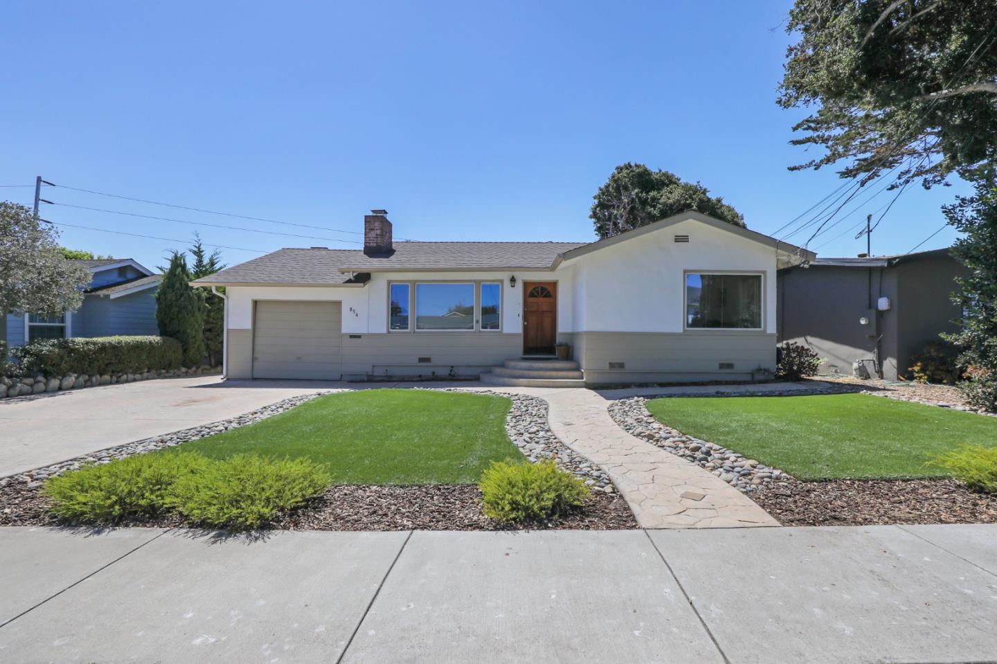 a front view of a house with a garden